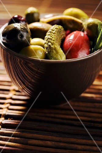 Bowl of Assorted Olives with a Gherkin Pickle