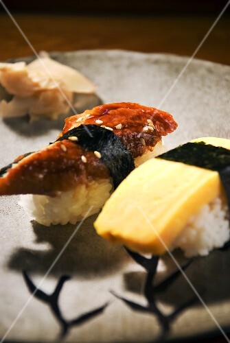 Eel and Egg Sushi with Ginger on a Gray Plate