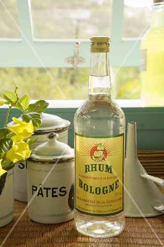 Bottle of Rum on a Counter by an Opened Window