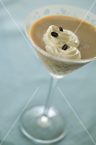 A Coffee Martini with Whipped Cream and Coffee Beans
