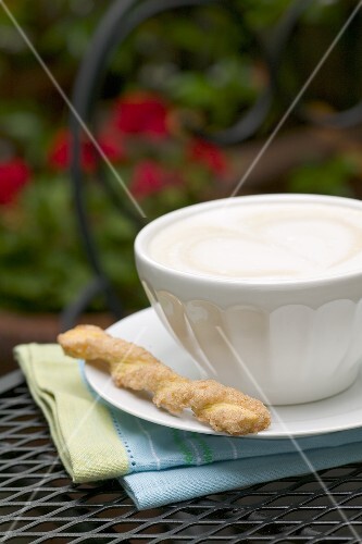 Cappuccino with a Cookie on an Outdoor Table
