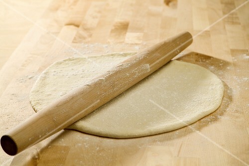 Rolling Pin on Rolled Out Pizza Dough