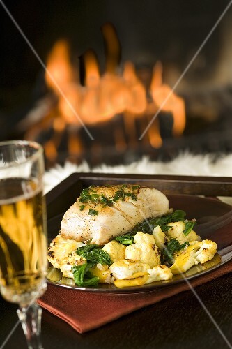 Cod Fillet with Cauliflower and White Wine in Front of a Fireplace