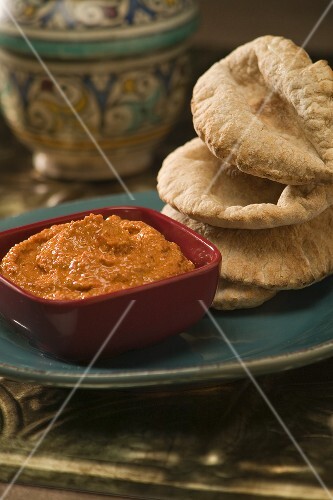 Mahammara Dip Made with Red peppers, Walnuts and Olive Oil, with a Stack of Pita Bread