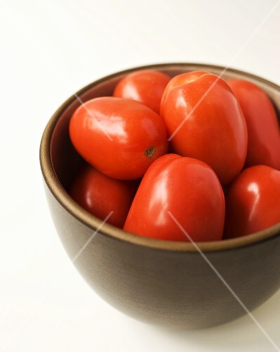 Organic Roma Tomatoes in a Brown Bowl