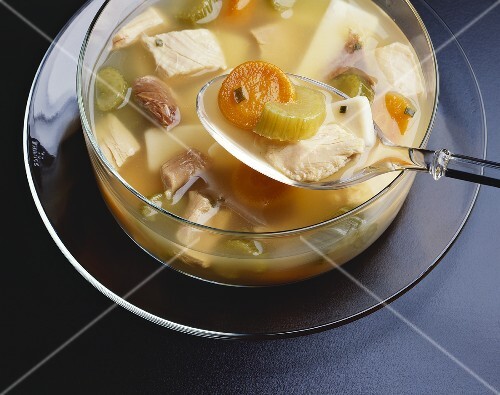 Spoonful Over a Bowl of Chicken Noodle Soup