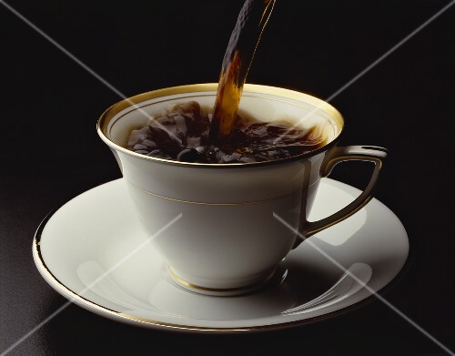 Coffee Pouring into a Bone China Cup