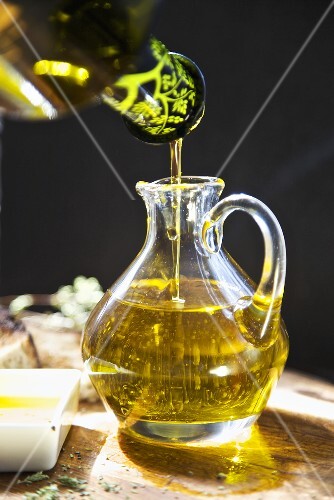 Cold Press, Organic Virgin Oil Pouring into a Small Pitcher