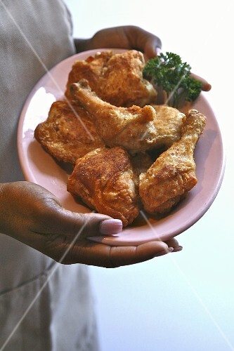 Woman Holding a Plate of Organic Fried Chicken