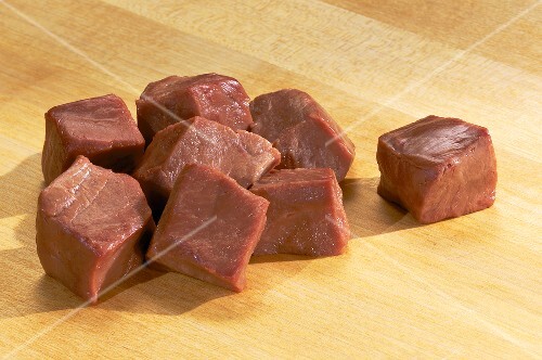 Raw Beef Cubes on Wood