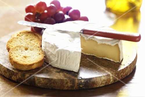 Brie Cheese with Crostini and Grapes on Marble