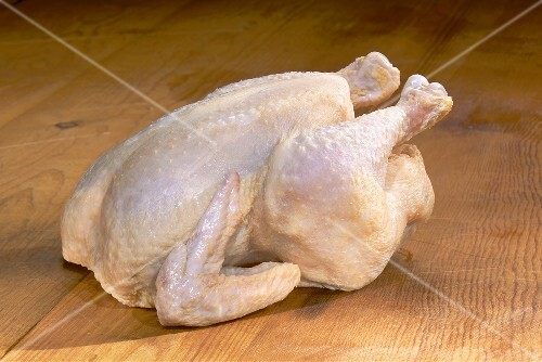 Whole Raw Chicken on Wood