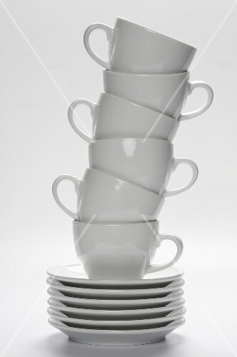 White Coffee Cups Stacked on Stacked Saucers