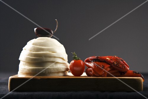 Sliced Mozzarella Cheese; Roasted Red Peppers on Cutting Board