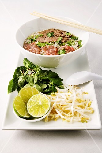Pho; Vietnamese Sliced Meat and Rice Noodle Soup in Bowl with Chopsticks