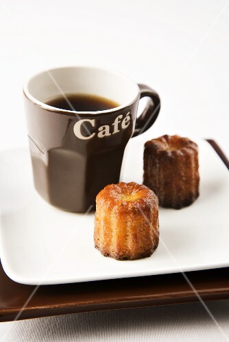Two Cannele with a Cup of Coffee in Brown Mug
