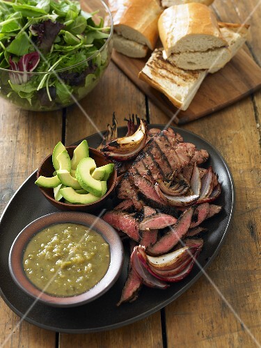 Sliced Grilled Steak and Avocado on a Platter for Steak Sandwiches