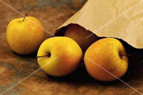 Ginger Gold Apples Spilling From Paper Bag