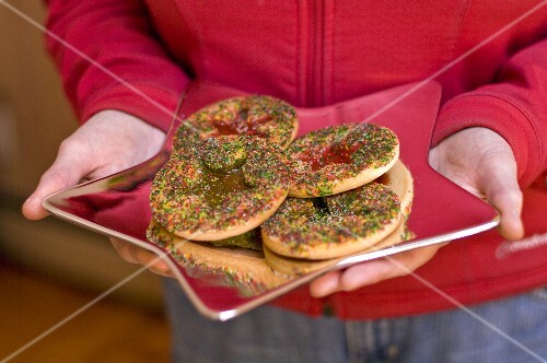 Person Holding a Star Plate with Christmas Cookies