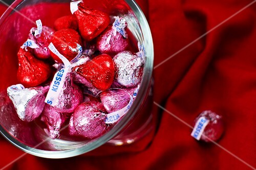 Red, Pink and Silver Chocolate Kisses in a Glass Dish; From Above