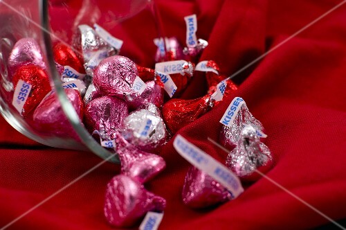 Pink, Red and Silver Chocolate Kisses Spilling From a Bowl